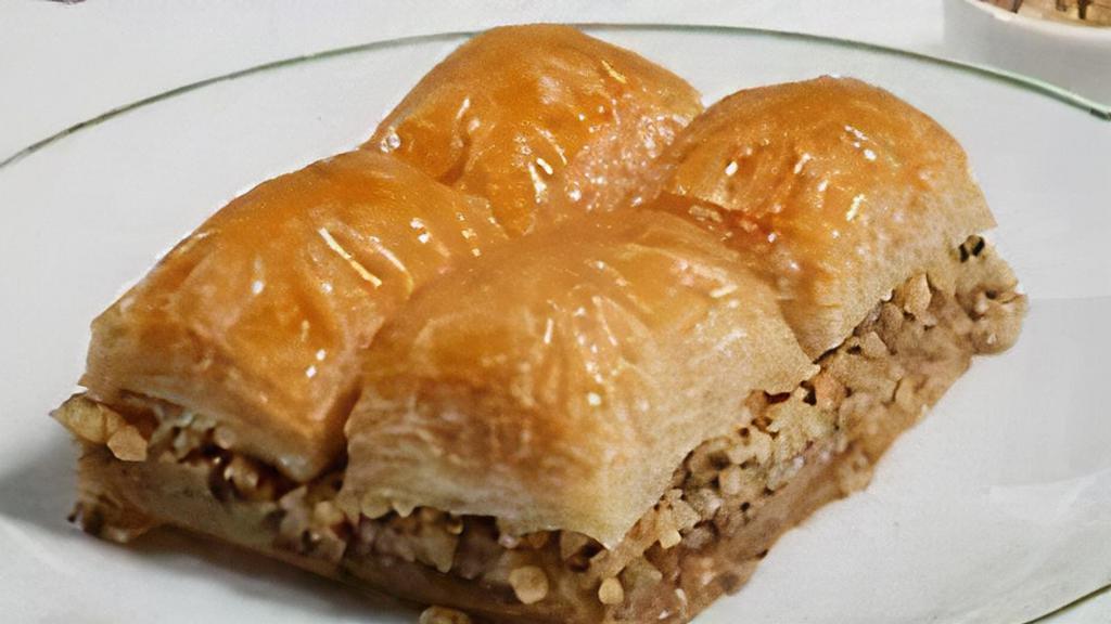 Baklava · Sweet dessert pastry with layers of filo dough filled with chopped walnuts sweetened and held together with syrup and honey.