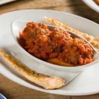 Meatballs · Homemade meatballs topped with Parmigiano Reggiano, served with tomato sauce, basil & toaste...