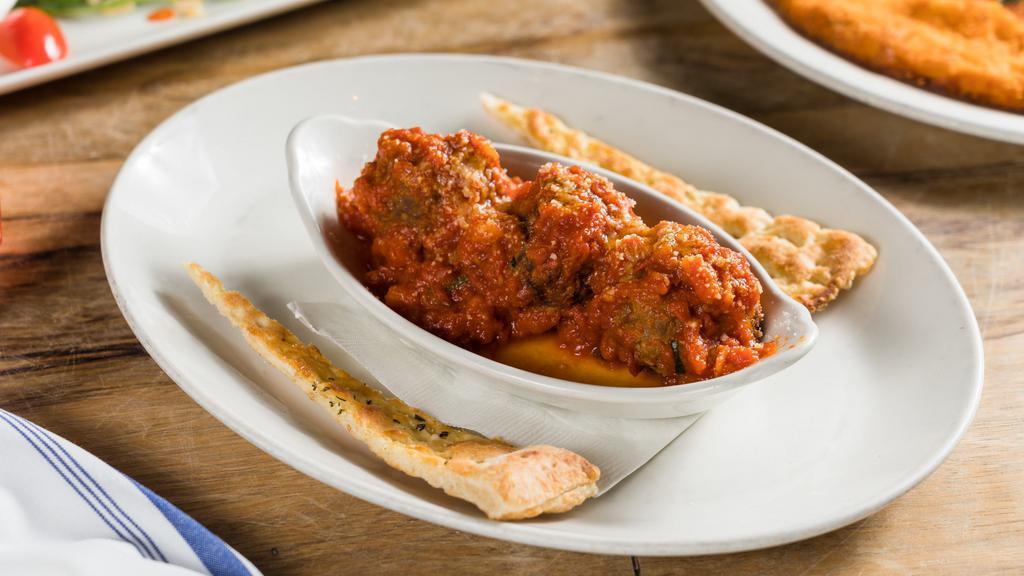 Meatballs · Homemade meatballs topped with Parmigiano Reggiano, served with tomato sauce, basil & toasted bread.