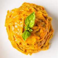 Paglia & Fieno · Homemade white & spinach fettuccine, tomato sauce, basil, Parmigiano Reggiano & a touch of c...