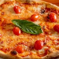 Margherita Pizze · Tomato, fresh homemade mozzarella, fresh basil, and olives.