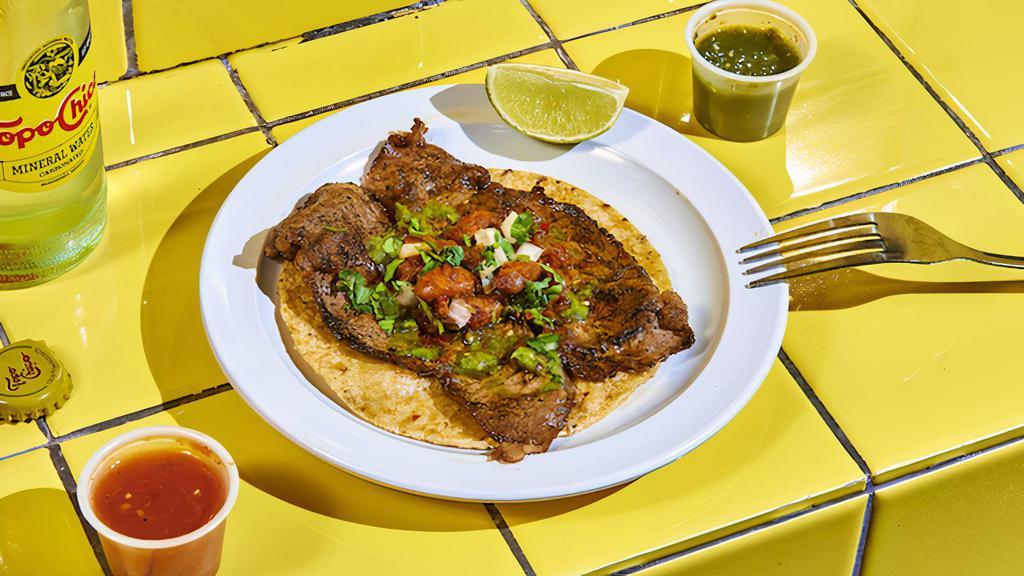 Carne Asada. · Sonoran-style carne asada. Thinly sliced sirloin, topped with cilantro, onion and avocado-tomatillo salsa.