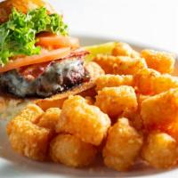 Black & Bleu Burger · Topped with crispy bacon, melted bleu cheese, lettuce, tomatoes and onion jam