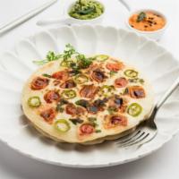 Uttapam · An Indian lentil and rice pancake mixed with herbs and spices.