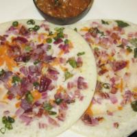Onion Uttapam · An Indian lentil and rice pancake mixed with herbs, spices and sautéed onions.