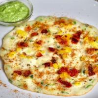 Egg Uttapam · An Indian lentil and rice pancake mixed with herbs, spiced and stuffed with a cooked egg.