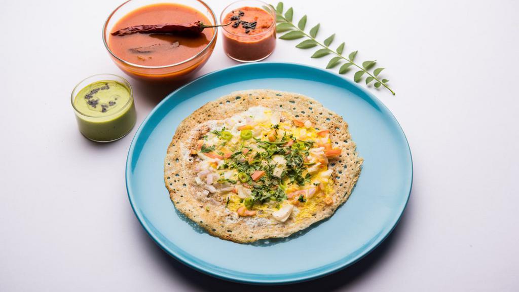 Egg Dosa · A fresh made thin Indian crepe made from a fermented batter of lentils and rice stuffed with a fresh made omelette and spices.