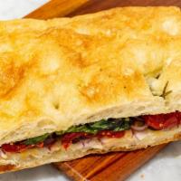 Berta · Half Size Sandwhich on Focaccia Bread, Paper thin fresh onion, sun-dried tomatoes, basil, EVOO
