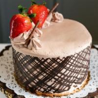 Chocolate Mousse Cake · Serves 8-10 people. Rich layers of chocolate cake, filled with chocolate mousse and iced in ...