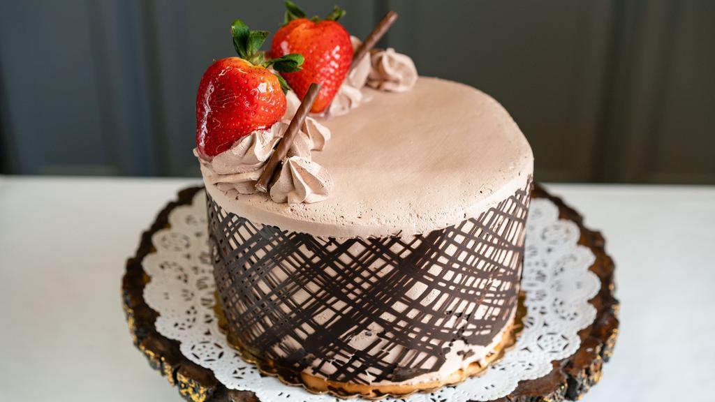 Chocolate Mousse Cake · Serves 8-10 people. Rich layers of chocolate cake, filled with chocolate mousse and iced in a smooth chocolate whiped cream, covered in a dreamy chocolate ganache.