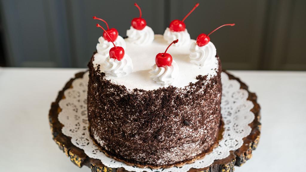 Black Forest Cake · Serves 8-10 people. A rich chocolate cake filled with chocolate whipped cream and cherries, iced with a thin layer of whipped cream and finished with chocolate shavings and cherries.