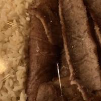Gyro Dinner · Thinly sliced gyro meat served over our house-made rice with a small Greek salad and a side ...