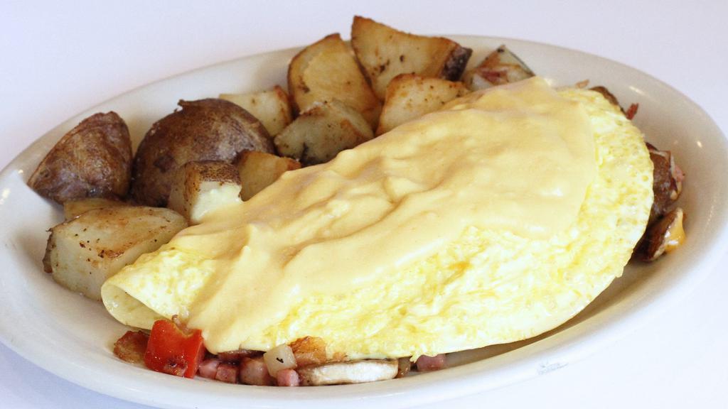House Special Omelette · Ham, bacon, Portuguese sausage, tomato, onion, bell pepper, mushroom, potato, cheese and hollandaise.