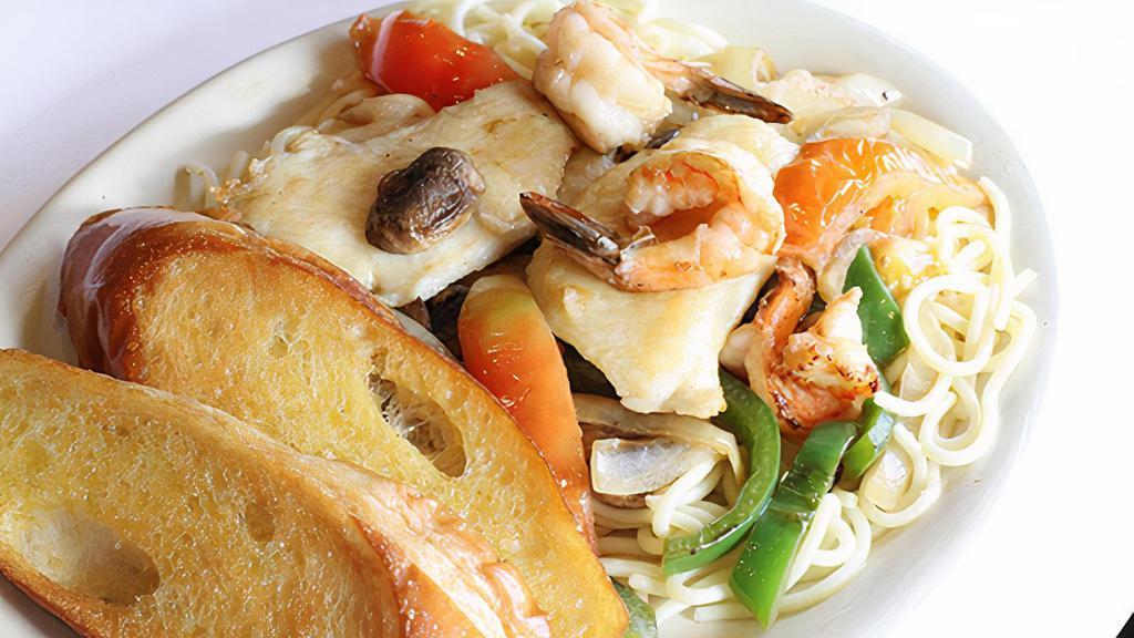 Sautéed Shrimp & Fish · Served on a bed of pasta with garlic bread.