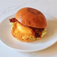 Bacon Egg + Cheese · Bacon, runny egg, aged cheddar, spicy aioli, butter lettuce, tomato on brioche.