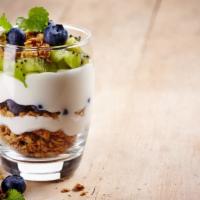 Yogurt Parfait · Yogurt topped with fresh fruit and crunchy granola with honey drizzle.