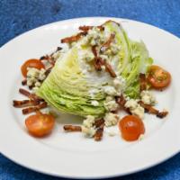 Iceberg Lettuce Wedge · Hickory-smoked bacon crumbles, tomatoes, blue cheese dressing.