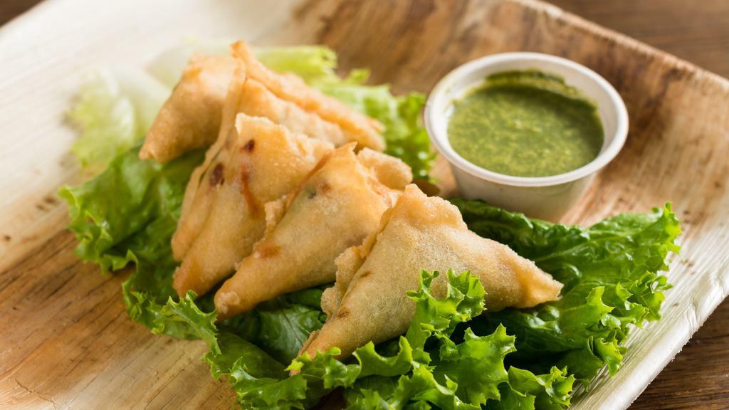 Curry Samosas · House-made pastries with mint chutney dip.