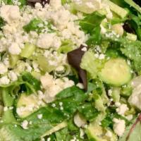 Prasini Salad · Crisp romaine lettuce,| scallions, dill cucumbers, crumbled feta cheese, and Mykonos vinaigr...