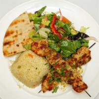 Chicken Souvlaki · Marinated cubes of delicious grilled chicken on a skewer with rice pilaf  pita bread and sma...