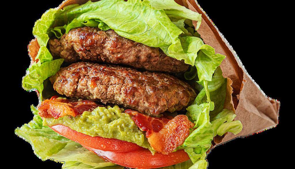 Paleo Burger · This wholly healthy, low-carb burger features two 100% grass-fed, organic beef patties topped with guacamole, bacon and tomatoes wrapped in lettuce.