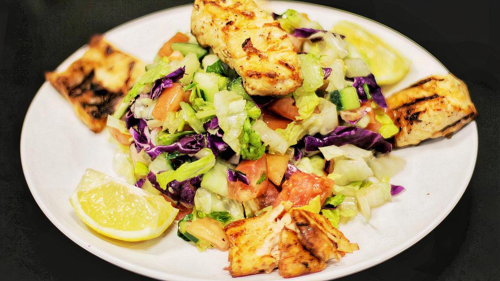 Grilled Salmon Salad · House salad made by lettuce, tomato and cucumber, vinegar and olive oil. Served with grilled salmon on top.