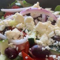 Greek Salad · Spring mix, tomatoes, cucumbers, olives, roasted red peppers, red onion, feta cheese with Gr...