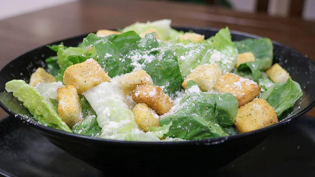 Caesar Salad With Chicken · Romaine Lettuce, Chicken, Parmesan Cheese, and Croutons. Comes with Caesar Dressing on the side.