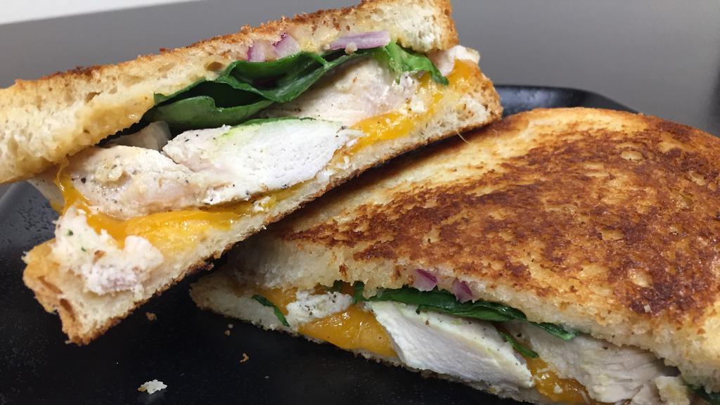 Chipotle Chicken Panini · Chicken, chipotle ranch, cheddar cheese, red onion, and spinach. Comes with chips and a pickle.