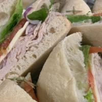 Roast Turkey And Provolone · Turkey, provolone cheese, romaine lettuce, and tomato on ciabatta. Comes with chips and a pi...