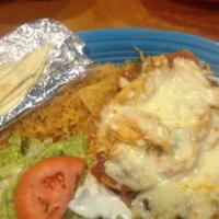 Chilaquiles · Tortilla Chips Covered with Ranchero or Tomatillo Sauce, Chicken, Cheese, Rice, Lettuce, Gua...