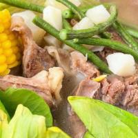 Bulalo · Slow cooked beef shanks with bone marrow soup with vegetables and corn.