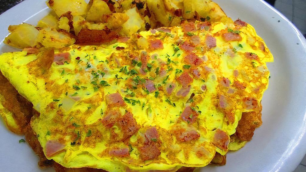 (O2) Meat Lover Omelette With Home Fries On Platter · Two eggs, ham, bacon, sausage, and cheese. Served with home fries and two sliced bread toasted with butter.