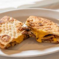 Philly Steak Panini · Grilled sliced steak, sauteed onions, and American cheese. On European flatbread. Served wit...