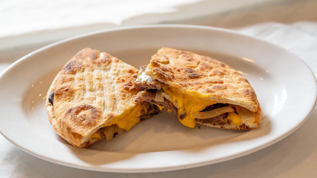 Philly Steak Panini · Grilled sliced steak, sauteed onions, and American cheese. On European flatbread. Served with chips.