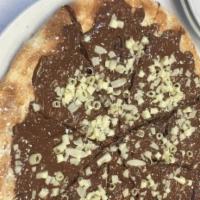 Pizza Nutella · Hazelnut chocolate spread topped with shaved white chocolate.