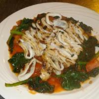 Grilled Calamari Over Fresh Sauteed Spinach Special · 