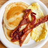 Pancakes · Two eggs any style, bacon sausage or ham, regular coffee, tea, or juice.