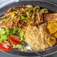 Pescado Frito Estilo San Juan / Fried Fish Puerto Rican Style · Fried red snapper (head on) sautéed with onion and green pepper served with rice and fried g...