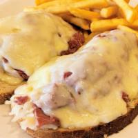 Corn Beef Reuben · Open faced hot corned beef 
On grilled rye with Swiss cheese and sauerkraut.
