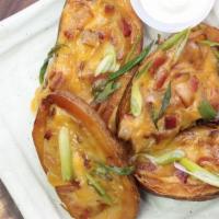 Potato Skins · Cheddar jack cheese, scallions, and sour cream.