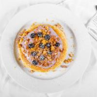 Blueberry Bourbon Pancakes · Our buttermilk batter pancakes with blueberry bourbon cream and almond brittle.