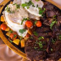 Skirt Antioqueno · Grilled Skirt Steak topped with fried egg,sauteed potatoes,white rice and beans. (Colombian ...