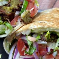 Falafel Wrap · Lettuce, tomato, cucumber, red onions, falafel, served with tzatziki or hummus.