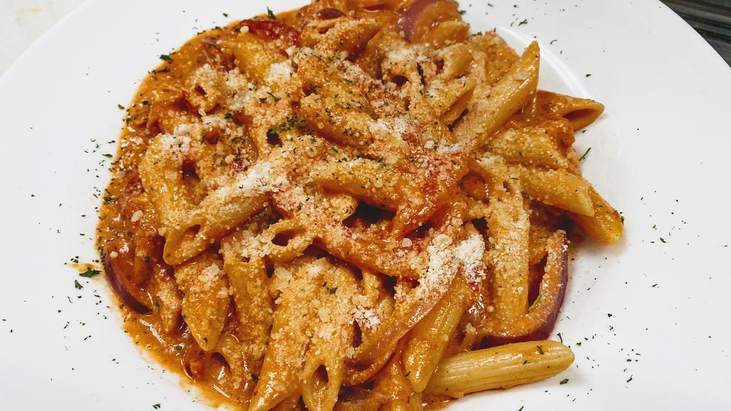 Penne Alla Vodka · Penne pasta tossed with a creamy marinara sauce  and vodka infused, seasoned with fresh herbs and parmesan.
