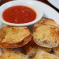 Garlic Bread · A great way to start your meal! Delicious garlic bread served with a side of tomato sauce fo...