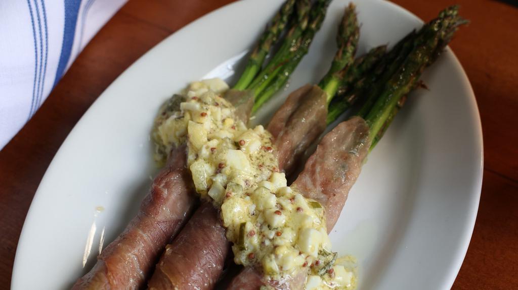Prosciutto Wrapped Asparagus · Tender spears of asparagus wrapped with prosciutto and topped with a mustard gribiche sauce. Gluten free.