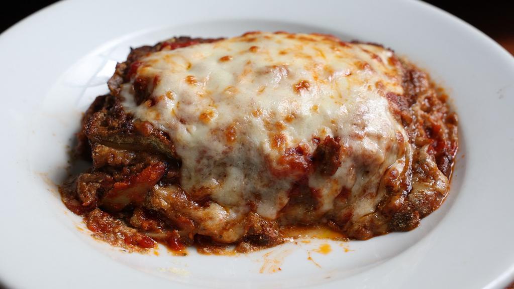 Veggie Lasagna · Layers of pasta, seasoned ricotta, pesto and veggie ragu, topped with tomato sauce and melted mozzarella cheese.