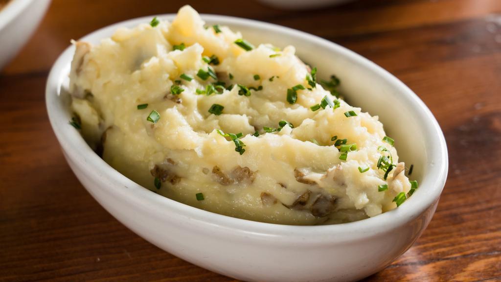 Mashed Potatoes · Classic, creamy mashed potatoes prepared from Yukon Gold potatoes, topped with chives.