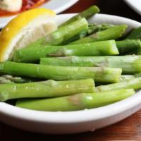 Asparagus · Tender spears of asparagus topped with a light lemon vinaigrette. Vegan and gluten free.